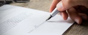 hand signing a letter